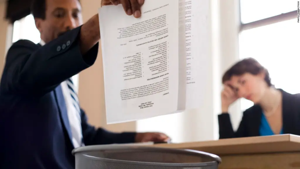 Businessman throwing away report into trash